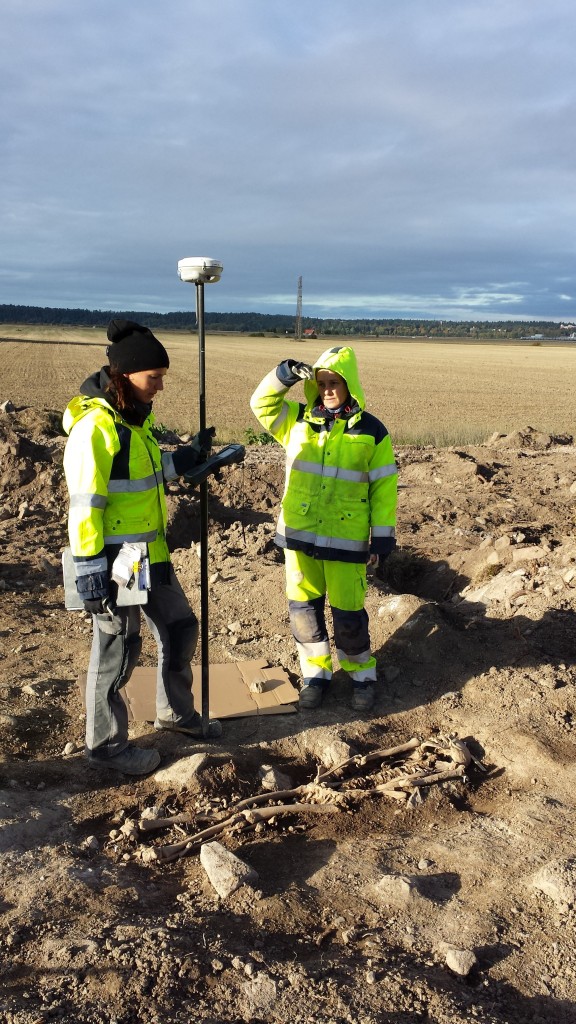 Emma Sjöling och Sofia Prata mäter in skelettet i en av gravarna som undersöktes. Foto: SAU/Upplandsmuseet.